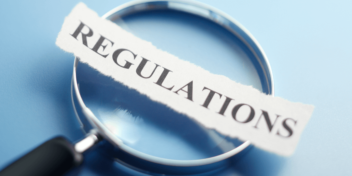 Magnifying glass highlighting the word “regulations”